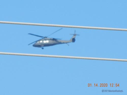 A lone military Blackhawk patrolled the BigM hillsides & canyons during the daytime on Jan. 14, 2020. It's seen here just over the BigM mountain - the wires are the power lines across the street from my home. These are the same power lines that have seemingly attracted UFO orbs here.